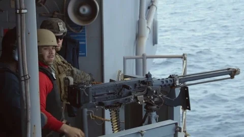 U.S. Navy Sailor looking through binoculars aboard USS Iwo Jimo Stock Footage 82780506