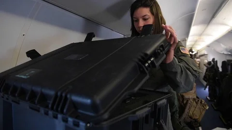 U.S. Navy sailor removing paperwork from case onboard P-8 Poseidon Video stock 110732288
