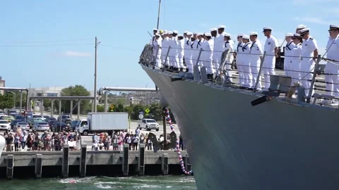 U.S. Navy sailors aboard USS Bainbridge (DDG 96) man the rails on arrival port Stock Footage 209492244