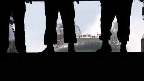 U.S. Navy sailors aboard USS Bataan waiting in well deck for approaching LCAC  Stock Footage 260234554