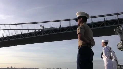 U.S. Navy sailors and Marines line deck of USS Bataan sailing under Verrazza Stock Footage 201072455