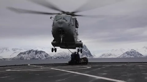 U.S. Navy sailors attaching load to Italian Navy Agusta Westland AW101 Stock Footage 267202329