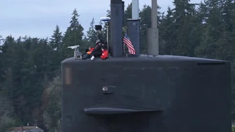 U.S. Navy sailors looking out from conning tower of USS Louisiana (SSBN 743) Stock Footage 233255871
