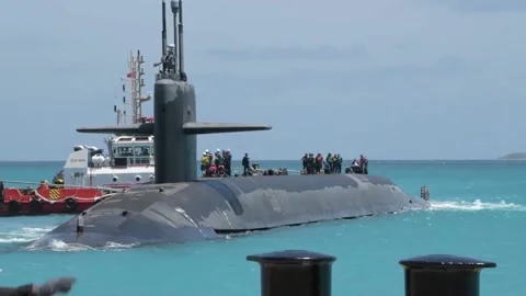 U.S. Navy sailors on upper deck of USS West Virginia as tugboat guides into port Stock-Footage 224488767