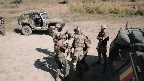 U.S. Navy SEALS carry under the arms of a wounded soldier Stock Footage 202224537