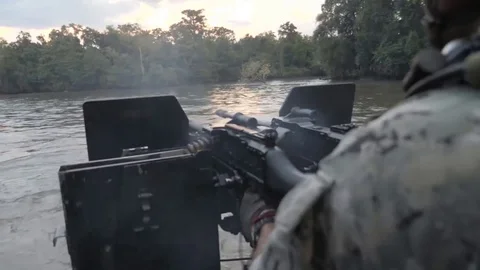 US Navy Special Warfare. Machine Gunner Shoots on a Boat Stock Footage 121890253