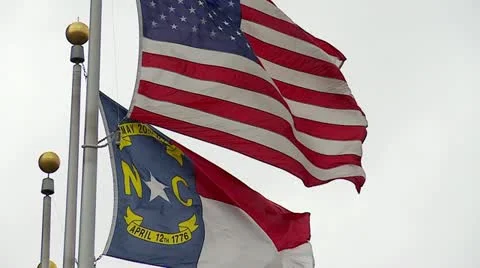US &amp; NC Flags in Wind Stock Footage 20582116