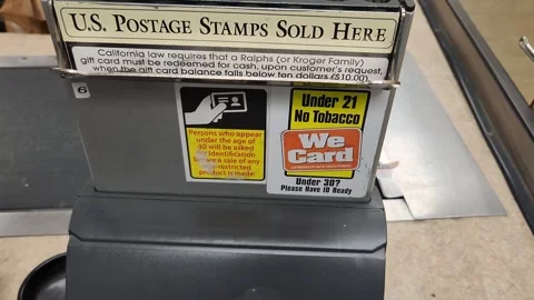 we sell tobacco here sign US Postage Stamps Sold Here We Card Under 21 No Tobacco