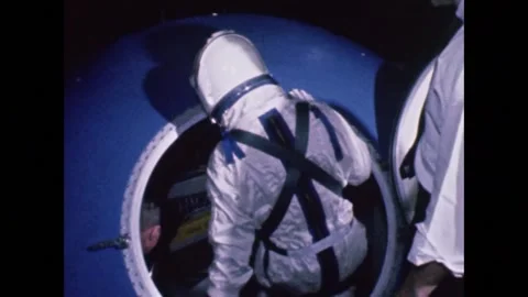 U.S. Project Gemini aastronaut climbing into space capsule for ingress training Stock Footage 263418642