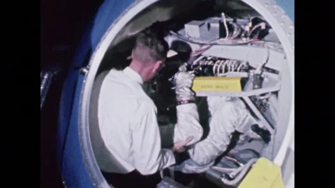 U.S. Project Gemini aastronaut climbing into space capsule for ingress training Stock Footage 263418652