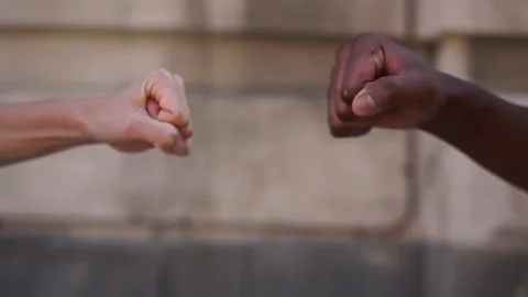 US protests concept. Close up a black fist and a white fist clashed in a clinch Stock Footage 133644652