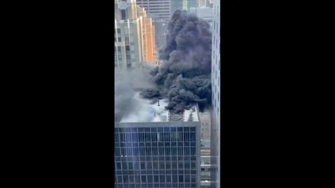 US: Rooftop Fire Breaks Out Near NYC St. Patricks Day Parade in Midtown ... Stock Footage 331076809