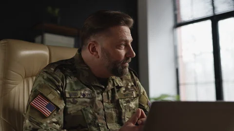 U.S. service member experiencing work stress while analyzing data on laptop Stock Footage 331497834