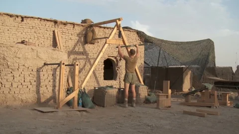 US soldier preparing a workout zone in a base camp in the Middle East Video stock 85603121