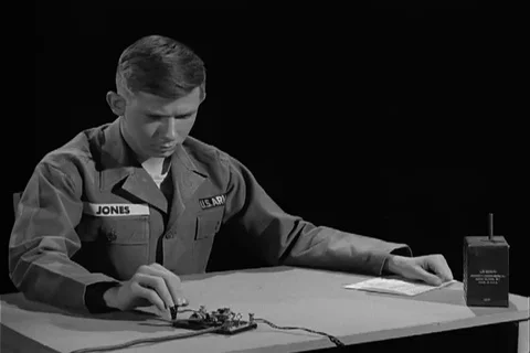 U.S. soldier send morse code by operating the hand key - 1966 Stock Footage 108332364