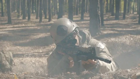 US soldiers in camouflage fight with the enemy in a smoky forest Stock Footage