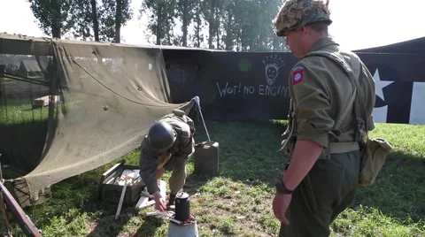 US Soldiers prepare coffee in front of glider Stock Footage 41818593