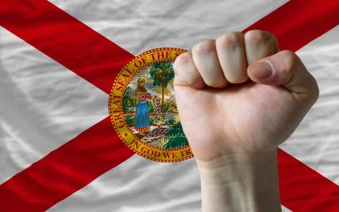 Us state flag of florida with hard fist in front of it symbolizing power Stock Photos