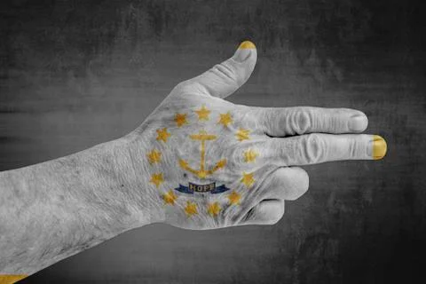 US state flag of Rhode Island painted on male hand like a gun Stock Photos