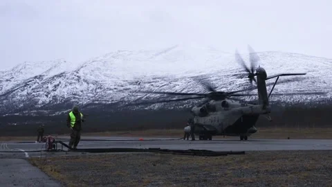 U.S. Super Stallion Helicopter Taking off and Flying Over Snowy Mountains Stock Footage 130358093