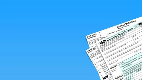 US tax forms including 1040 are displayed against a vibrant blue background Foto stock