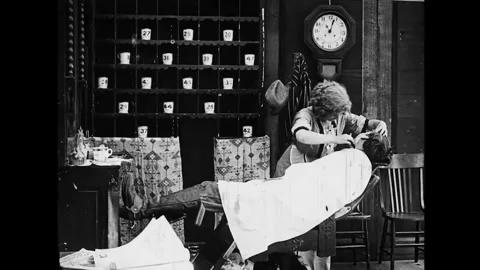 USA - 1912 - In this silent comedy, a pretty barber takes all of a competitor's Stock Footage 340655437