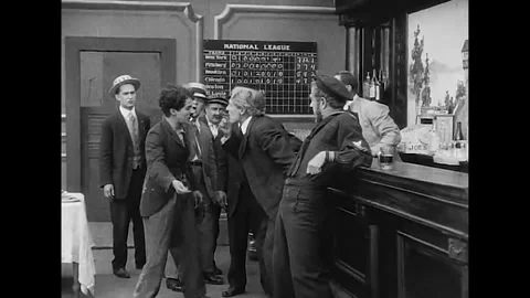 USA - 1914 - In this silent comedy, a drunk artist (Charlie Chaplin) fights Stock Footage 340574216