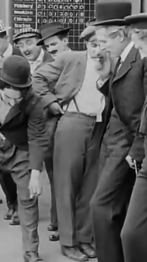 USA - 1914 - In this silent comedy, a drunk man (Charlie Chaplin) gets kicked Stock Footage 342804986