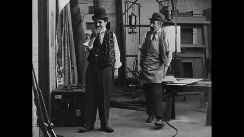 USA - 1915 - In this silent comedy, an actor (Charlie Chaplin) gets shy around a Stock Footage 340580973