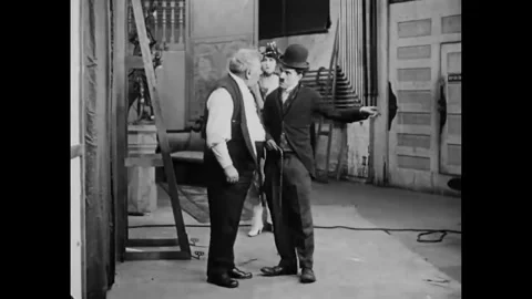 USA - 1915 - In this silent comedy, an actor (Charlie Chaplin) gets violently Stock Footage 340581039