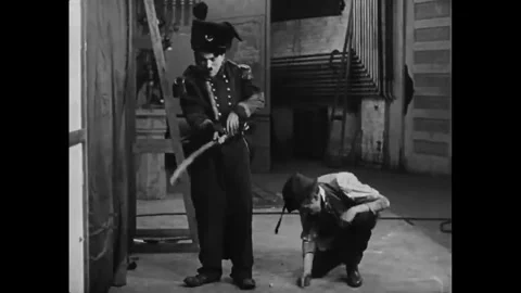 USA - 1915 - In this silent comedy, an actor (Charlie Chaplin) commits slapstick Stock Footage 340581104