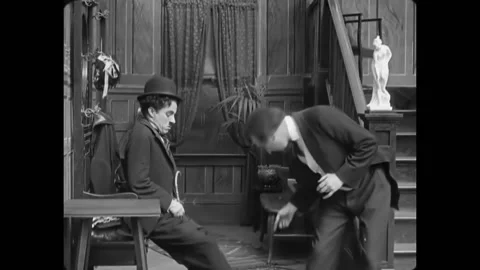 USA - 1915 - In this silent comedy, a man mistakes a tramp (Charlie Chaplin) for Stock Footage 277300151