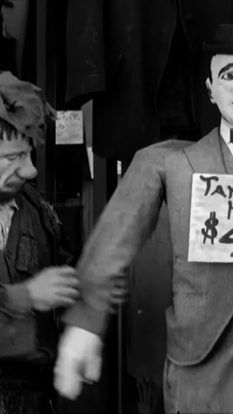 USA - 1916 - In this silent comedy, a bum pumps a mannequin's arm for some water Stock Footage 340282307
