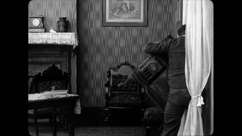 USA - 1916 - In this silent comedy, a delivery man enters a house through the Stock Footage 304422663
