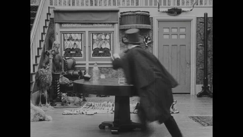 USA - 1916 - In this silent comedy, a drunk man (Charlie Chaplin) gets his Stock Footage 323261084