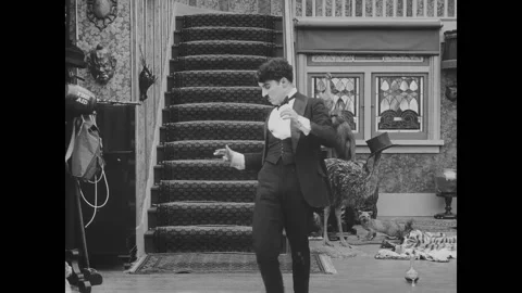 USA - 1916 - In this silent comedy, a drunk man (Charlie Chaplin) tries multiple Stock Footage 323265458