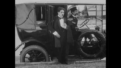 USA - 1916 - In this silent comedy, a drunk man (Charlie Chaplin) drops his Stock Footage 323265777