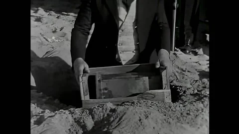 USA - 1920 - In this silent comedy, a man digs to find alcohol buried in the Stock Footage 327736324