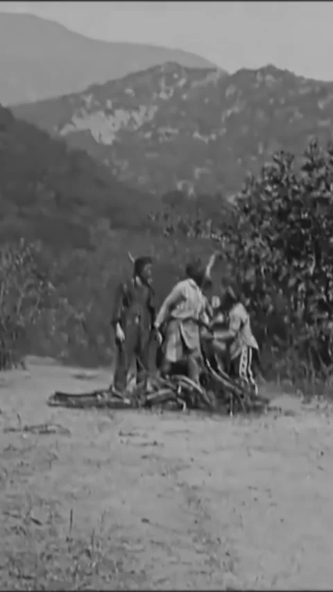 USA - 1922 - In this silent comedy western, Native Americans pile kindling to Stock Footage 342863662