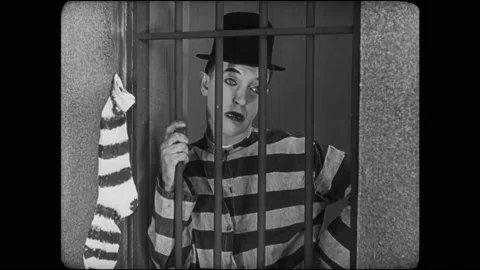 USA - 1924 - In this silent comedy, guards taunt convicts by hanging pickaxes Stock Footage 327682193