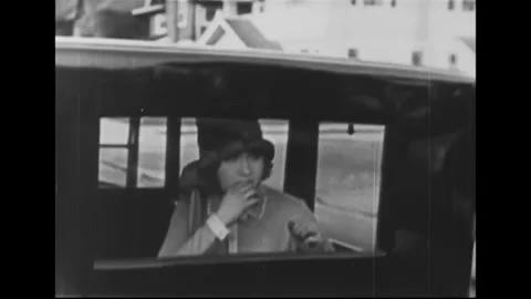 USA - 1925 - In this silent comedy, a man sits in the backseat of a convertible Stock Footage 340656506