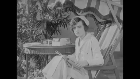 USA - 1925 - In this silent comedy, a nurse checks on an excited bedridden Stock Footage 323264625