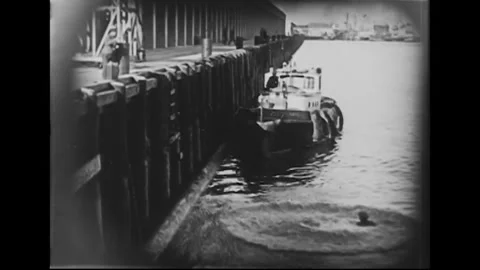 USA - 1925 - In this silent comedy, rescuers must use a crane to hoist a man out Stock Footage 340656265