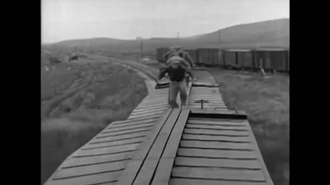 USA - 1927 - In this silent comedy, a man is chased along the top of train cars 스톡 동영상 296401191