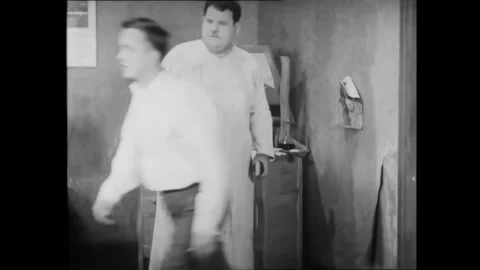 USA - 1929 - In this silent comedy, Laurel and Hardy both step on a nail and cry Stock Footage 340662692