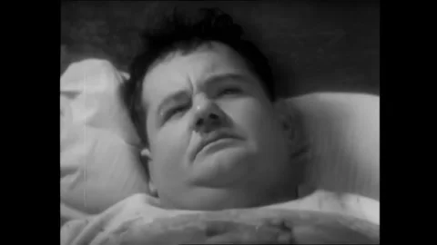 USA - 1929 - In this silent comedy, Laurel and Hardy have trouble sleeping with Stock Footage 340662760
