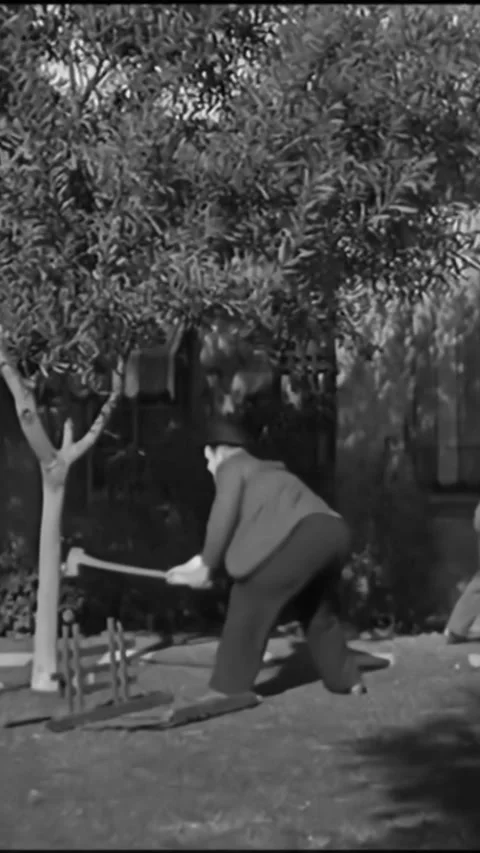 USA - 1929 - In this silent comedy, a man is ripping a vintage car to pieces Stock Footage 342623166