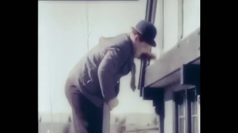 USA - 1929 - In this silent comedy, two men (Laurel and Hardy) use a ladder to Stock Footage 284813078