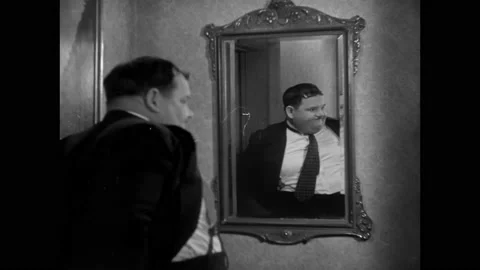 USA - 1930 - In this comedy, a man (Oliver Hardy) hides his hat after Stock Footage 330604699