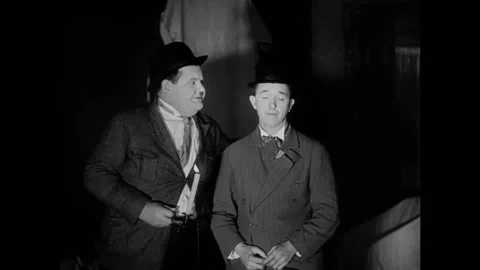 USA - 1930 - In this comedy, two men in bowler hats stand in a dark room with a Vídeos de archivo 325202050